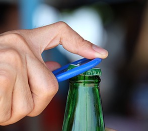 Man using bottle opener