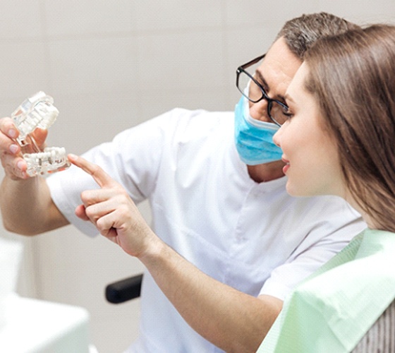 Implant dentist in Austin explaining treatment to a patient